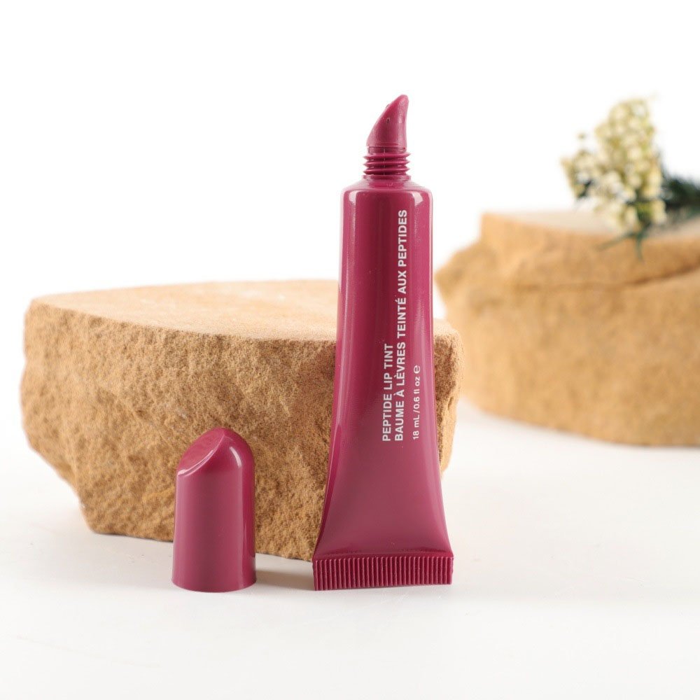 Empty lip gloss applicator cosmetic tube with plastic screw cap display